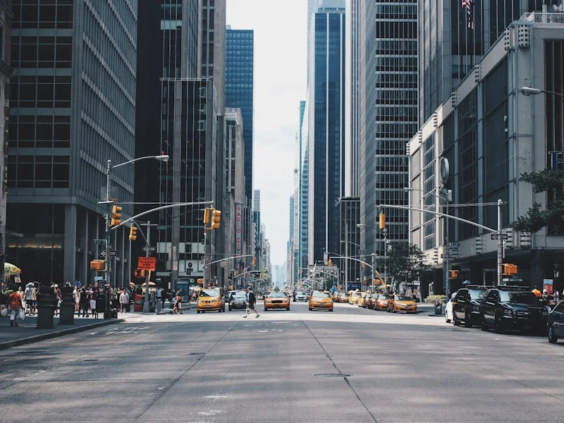 Taxis on a street between skyscrapers